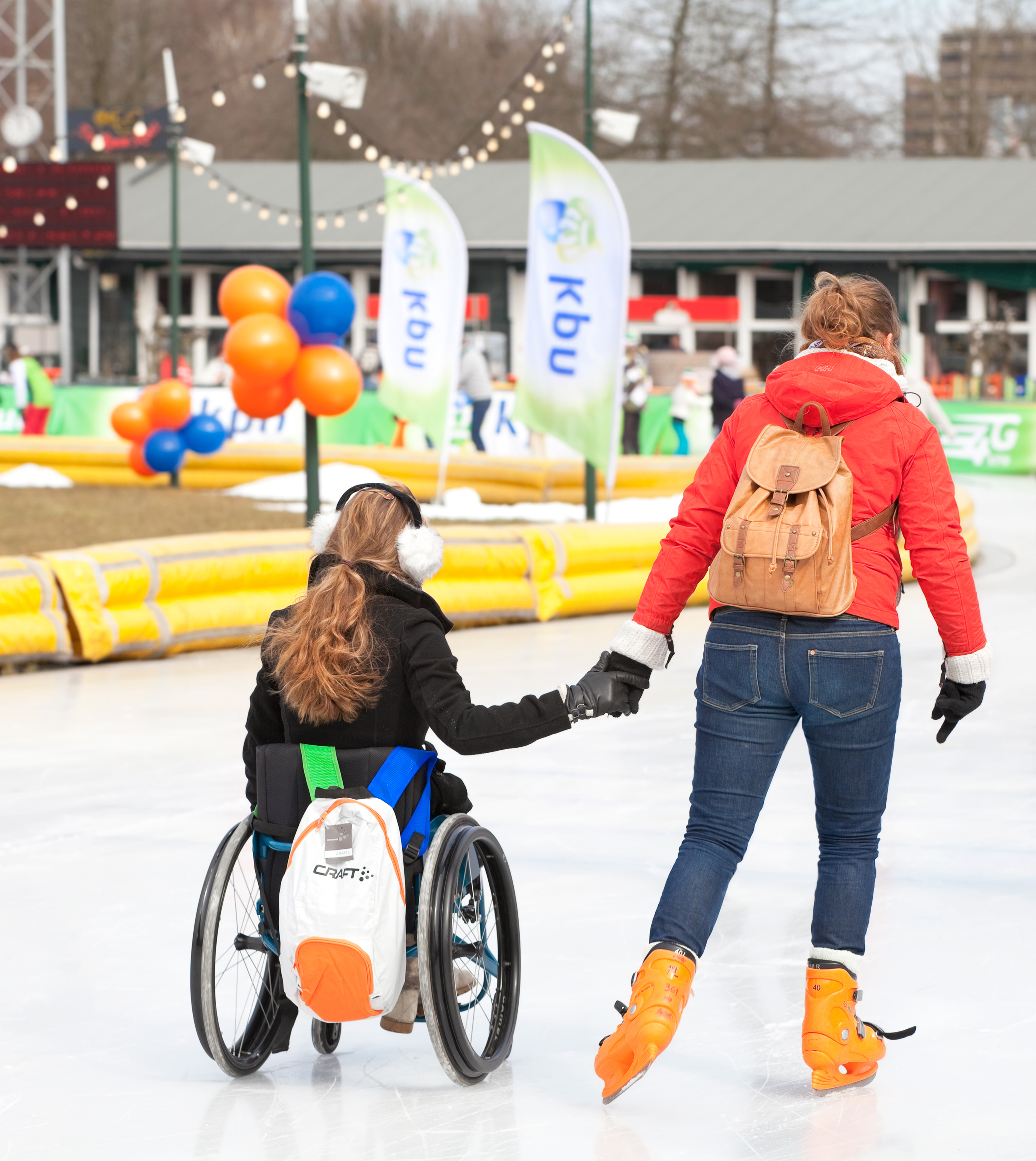 two-women-one-in-wheelchair-ice-skating